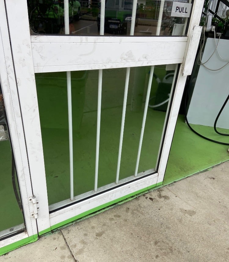 White security door with a replaced glass panel