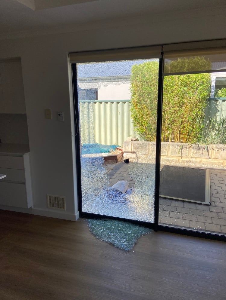 Smashed sliding door glass awaiting replacement