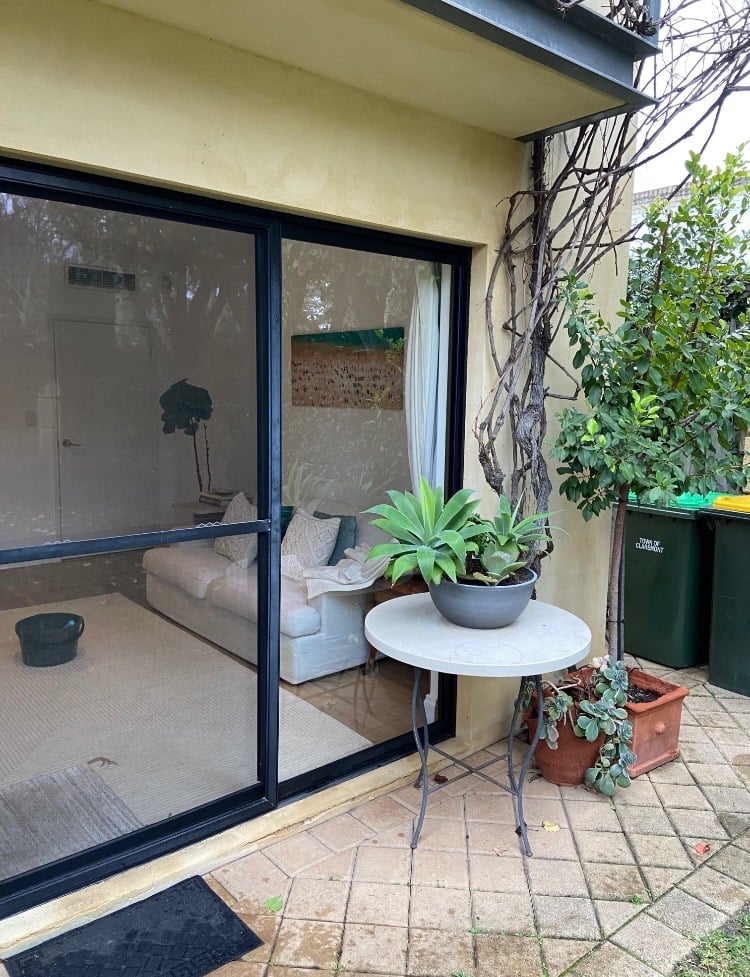 Black-framed sliding glass door after glass replacement