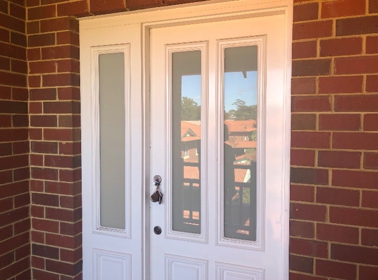 Front door with decorative glass sidelights