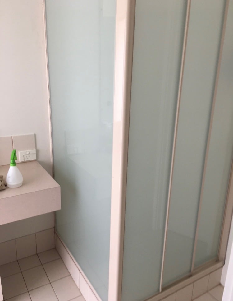 Frosted privacy glass panel installed in a home